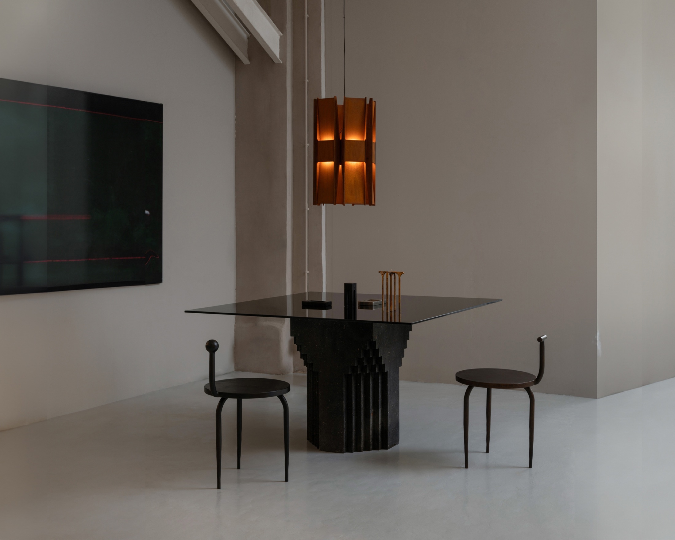 ANDlight Vector pendant photographed above a dark dining table