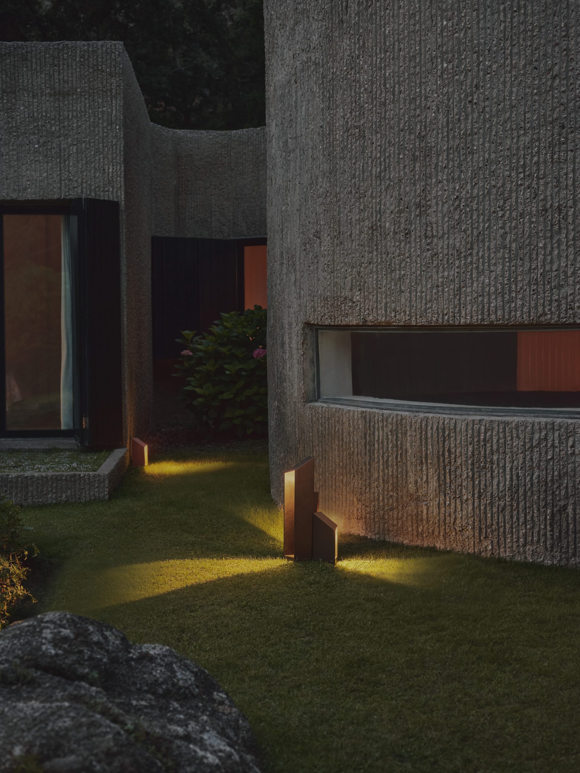 Marset Domus outdoor lights photographed illuminating a sculptural home and garden
